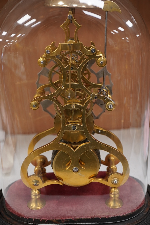 A Victorian skeleton clock under dome, cast iron base, 34cm total height